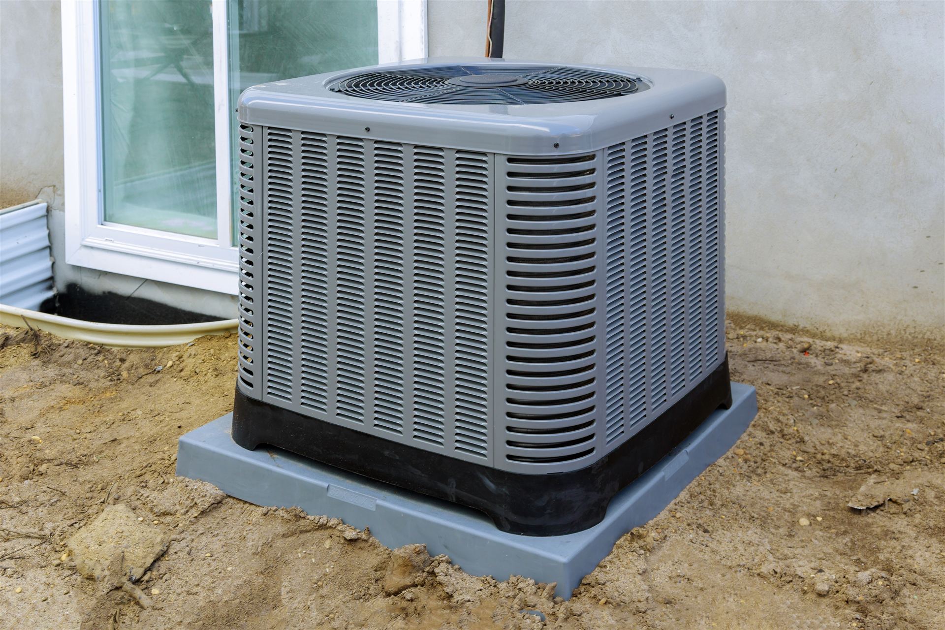 New central AC condenser installed outside a Miami-Dade home