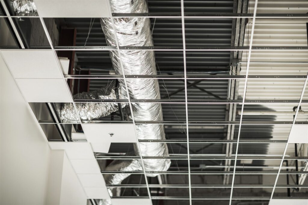 Commercial HVAC ductwork installed in a ceiling grid