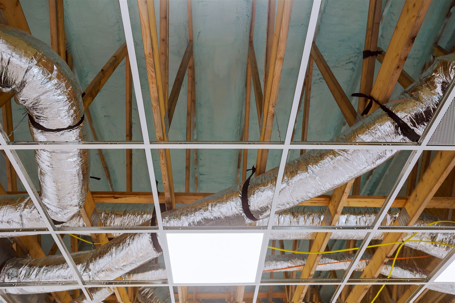 Flexible HVAC ducts routed through new construction framing